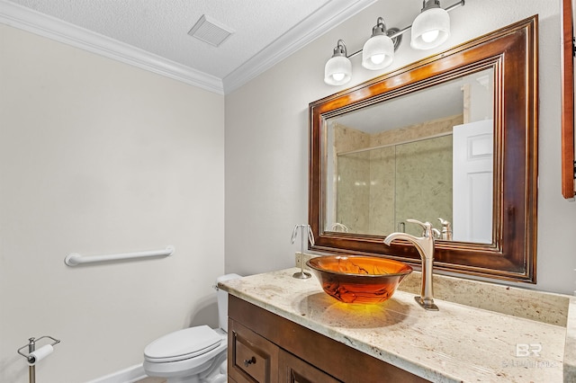 bathroom featuring toilet, a textured ceiling, walk in shower, ornamental molding, and vanity