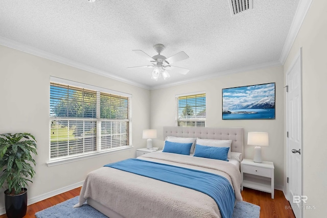 bedroom with dark wood-type flooring, ceiling fan, and ornamental molding