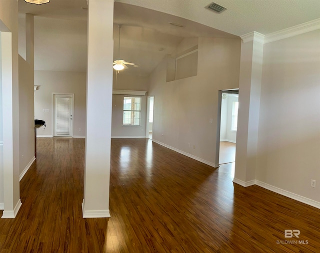 spare room with decorative columns, ceiling fan, high vaulted ceiling, and dark wood-type flooring