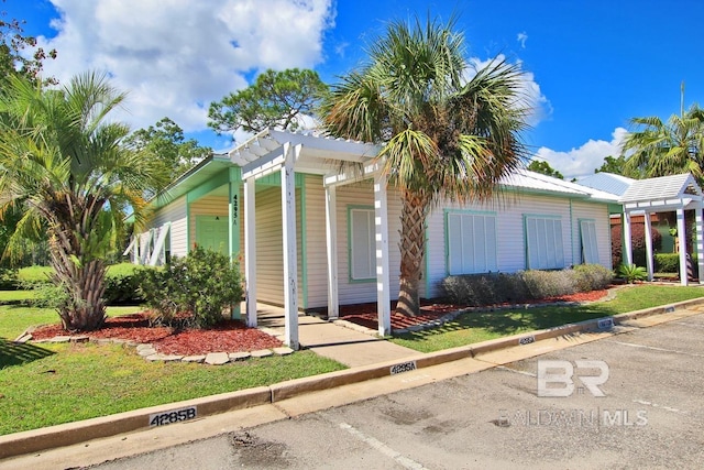 4295 Lindsey Ln Unit A, Orange Beach, AL 36561 - view of side of home featuring uncovered parking and a lawn