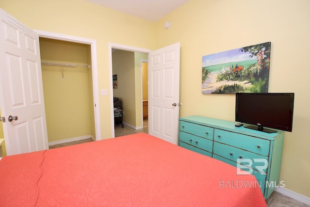 bedroom with a closet and baseboards