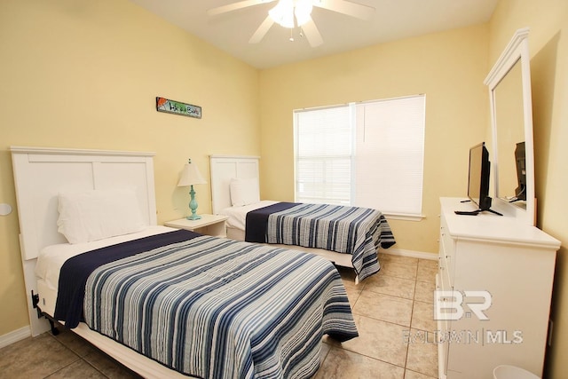 bedroom with light tile patterned floors, ceiling fan, and baseboards