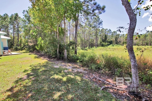 view of yard featuring a forest view