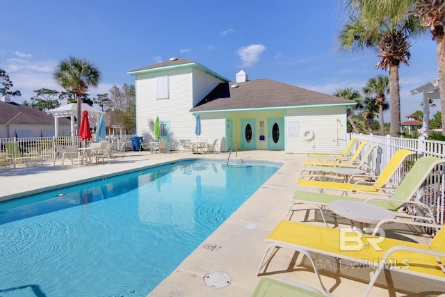 pool featuring a patio and fence