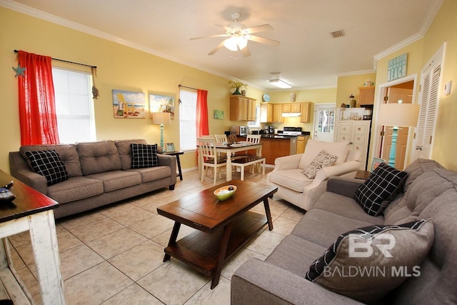 living room with ornamental molding, a healthy amount of sunlight, and light tile patterned floors