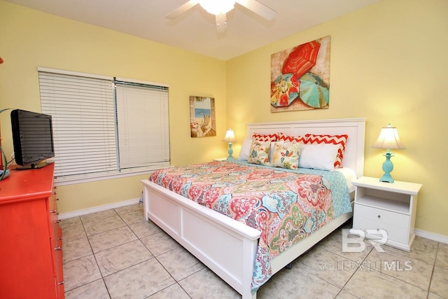 bedroom with light tile patterned floors, baseboards, and a ceiling fan