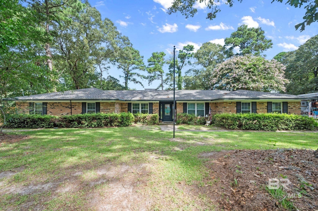 ranch-style house with brick siding and a front yard