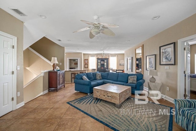 living room with ceiling fan and light tile floors