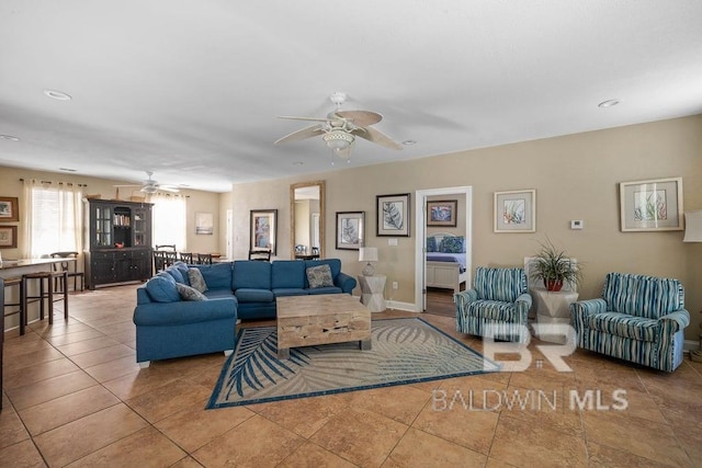 living room with light tile flooring and ceiling fan