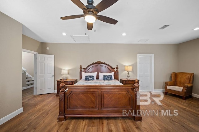 bedroom with dark hardwood / wood-style flooring and ceiling fan