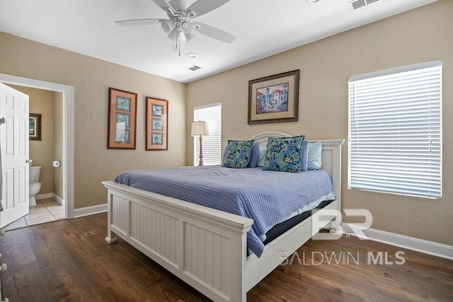 bedroom featuring ceiling fan, multiple windows, and dark wood-type flooring