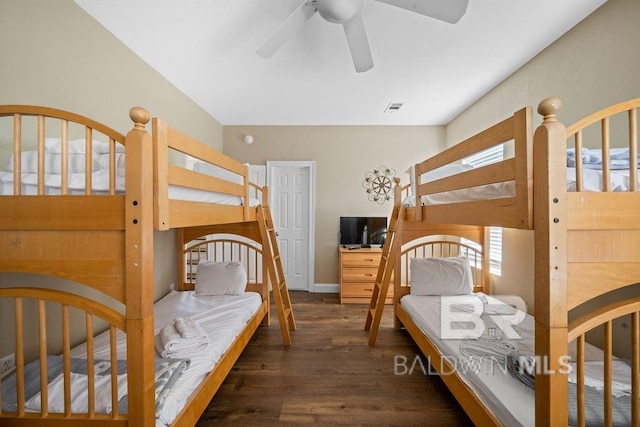 bedroom with ceiling fan and dark wood-type flooring