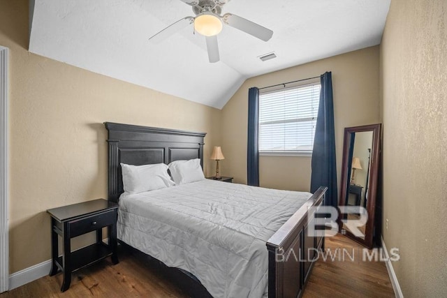 bedroom with lofted ceiling, ceiling fan, and dark hardwood / wood-style flooring