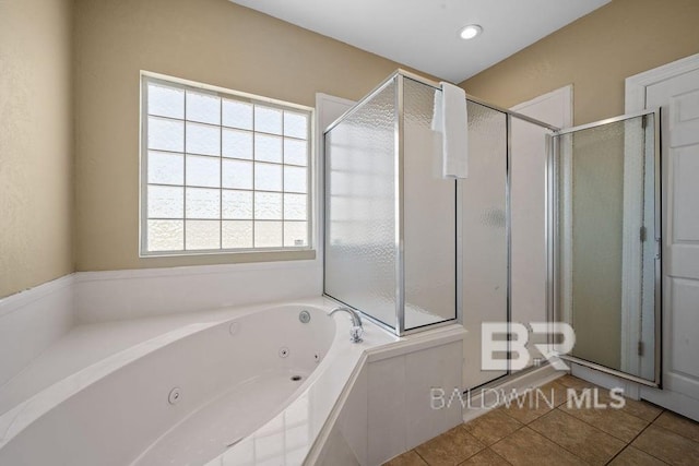 bathroom with tile flooring, independent shower and bath, and plenty of natural light