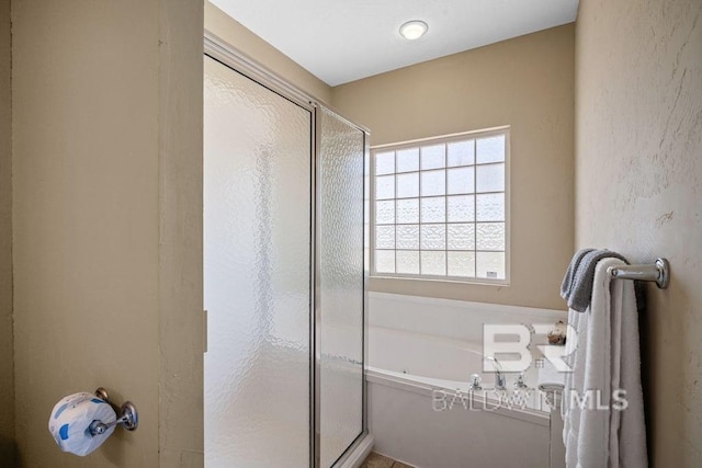 bathroom with shower with separate bathtub