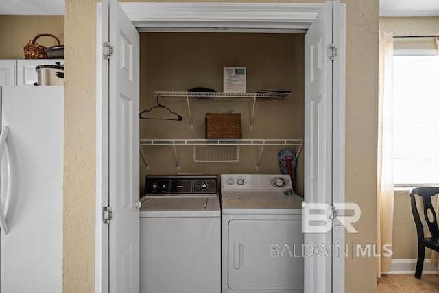 washroom featuring washer and clothes dryer