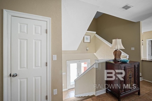 foyer entrance featuring dark tile flooring