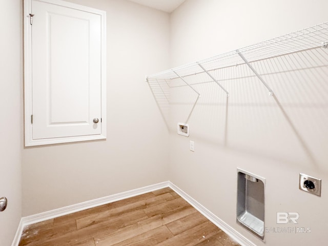 washroom with laundry area, hookup for an electric dryer, light wood-style floors, hookup for a washing machine, and baseboards