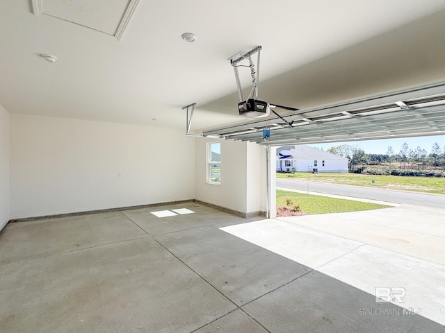garage with baseboards and a garage door opener