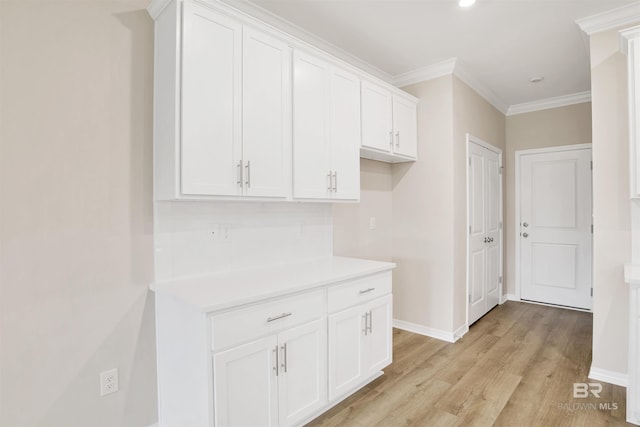interior space with recessed lighting, light wood-style floors, crown molding, and baseboards