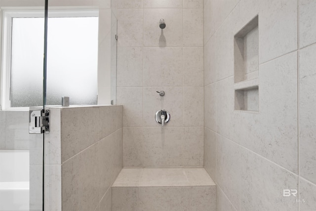 full bathroom featuring tiled shower