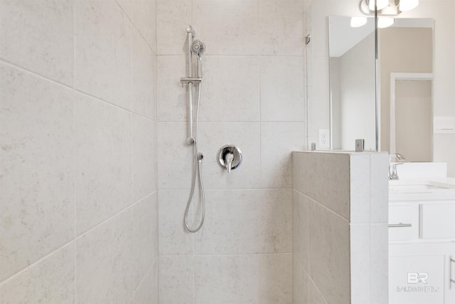 bathroom featuring vanity and tiled shower