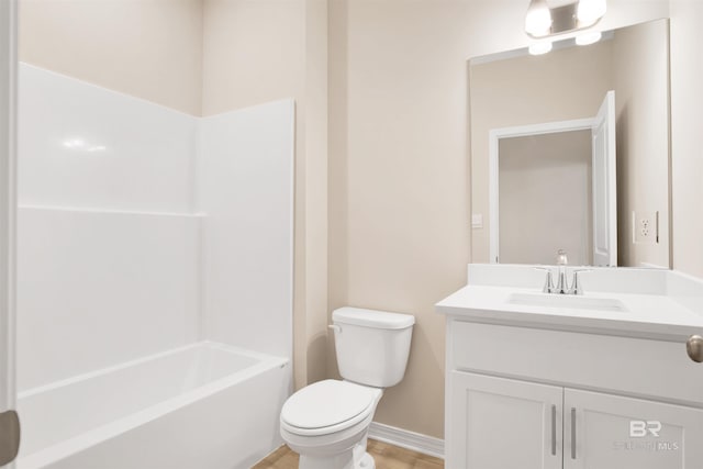 bathroom with toilet, baseboards, wood finished floors, vanity, and shower / tub combination
