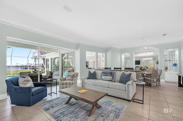 8160 Bay View Dr, Foley, AL 36535 - living room featuring light tile patterned floors, ornamental molding, a sunroom, baseboards, and a chandelier