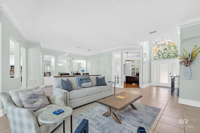 8160 Bay View Dr, Foley, AL 36535 - living area featuring light tile patterned flooring, arched walkways, crown molding, and baseboards