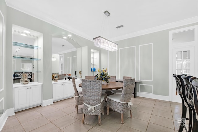 8160 Bay View Dr, Foley, AL 36535 - dining space with ornamental molding, light tile patterned floors, a chandelier, arched walkways, and recessed lighting