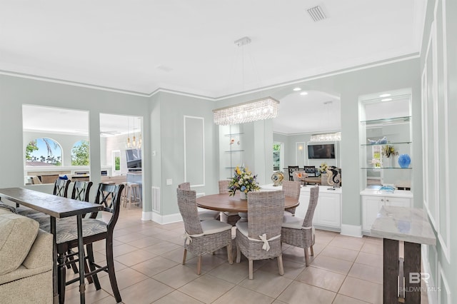 8160 Bay View Dr, Foley, AL 36535 - dining area featuring light tile patterned floors, a chandelier, ornamental molding, and baseboards