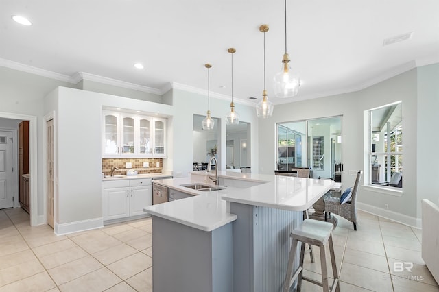 8160 Bay View Dr, Foley, AL 36535 - kitchen featuring a sink, light tile patterned flooring, white cabinets, light countertops, and ornamental molding
