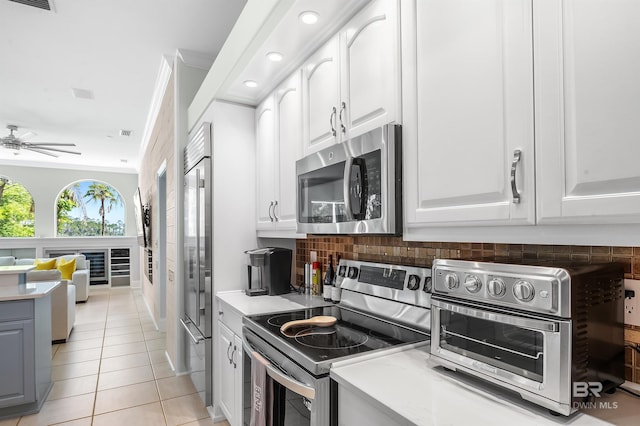 8160 Bay View Dr, Foley, AL 36535 - kitchen featuring appliances with stainless steel finishes, light countertops, backsplash, white cabinetry, and recessed lighting