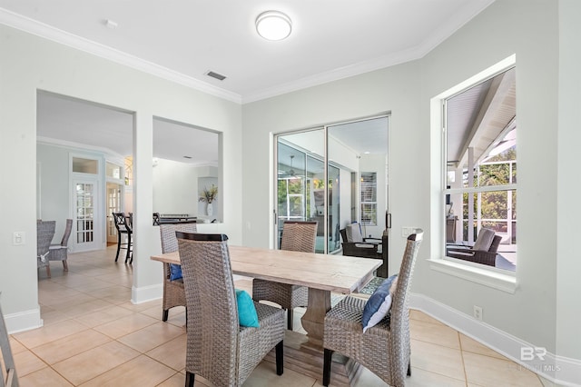 8160 Bay View Dr, Foley, AL 36535 - dining space featuring light tile patterned flooring, crown molding, and baseboards