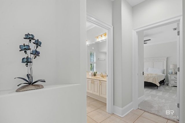 8160 Bay View Dr, Foley, AL 36535 - hallway featuring a sink, light tile patterned flooring, and light carpet