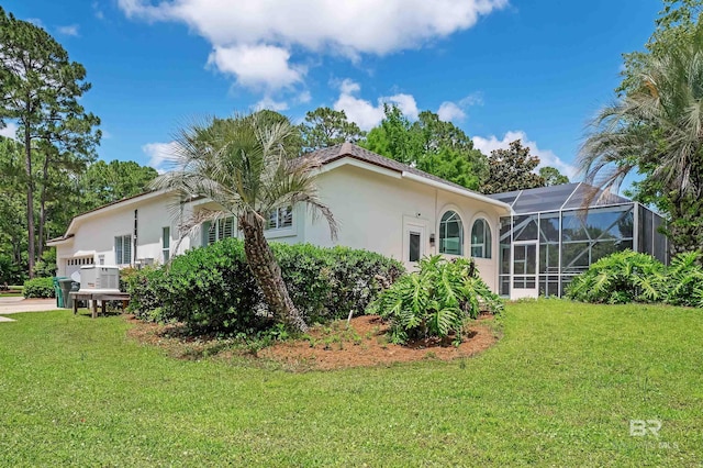 8160 Bay View Dr, Foley, AL 36535 - back of property featuring stucco siding, a lawn, and a lanai
