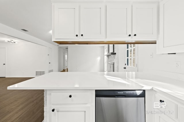 kitchen with dark hardwood / wood-style flooring, white cabinetry, dishwasher, and kitchen peninsula