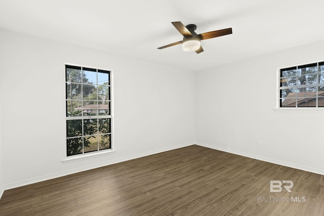 spare room featuring ceiling fan and dark hardwood / wood-style floors