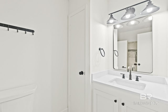 bathroom featuring toilet and vanity