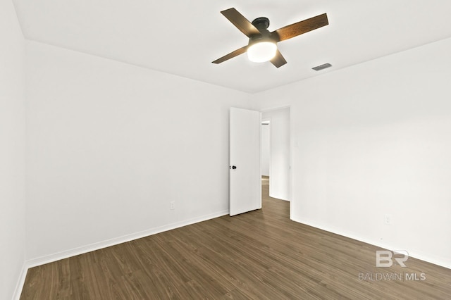 empty room with dark hardwood / wood-style flooring and ceiling fan