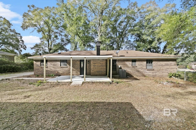 rear view of property with central air condition unit and a patio area