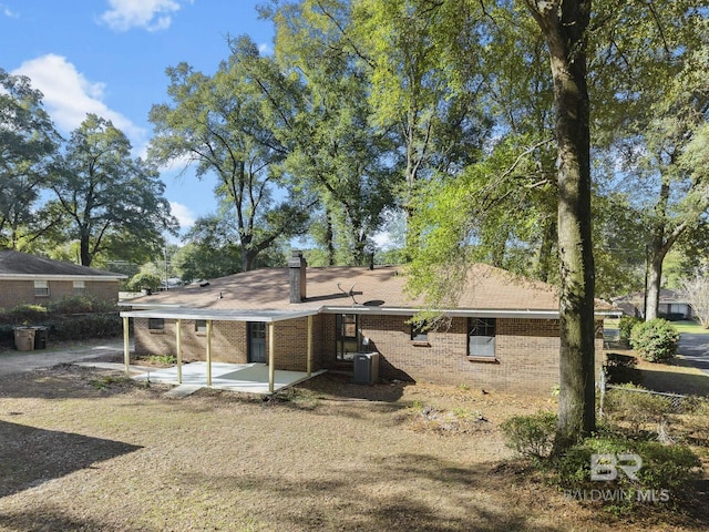 rear view of property with a patio and central AC