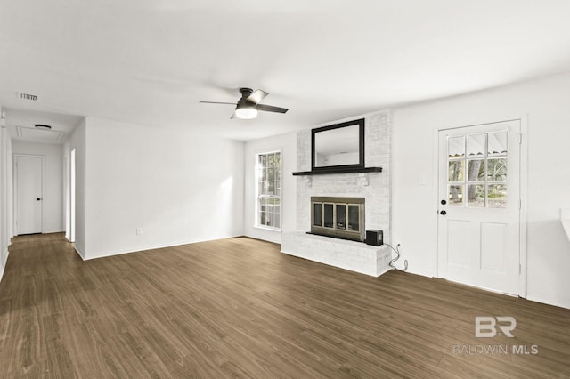 unfurnished living room with dark hardwood / wood-style flooring, a fireplace, and ceiling fan