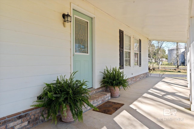 doorway to property featuring covered porch