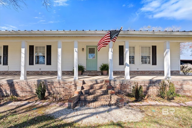 view of front of home featuring metal roof and a porch