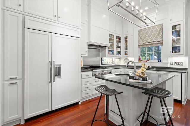 kitchen featuring sink, white cabinetry, stainless steel gas stovetop, a breakfast bar, and dark hardwood / wood-style floors