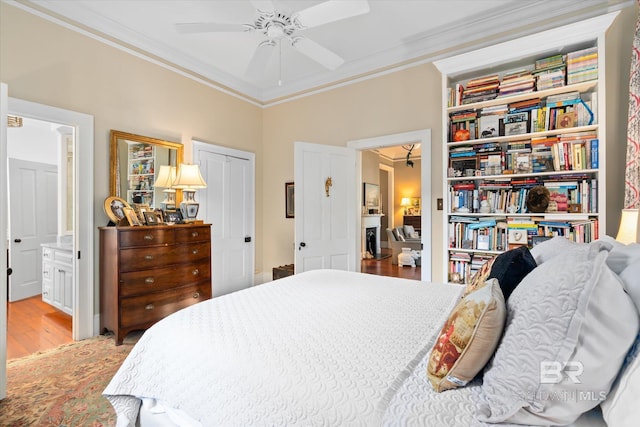 212 S Cedar St, Mobile, AL 36602 - bedroom featuring ornamental molding, light wood-type flooring, connected bathroom, a ceiling fan, and a closet