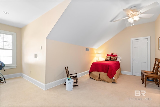 carpeted bedroom featuring lofted ceiling and ceiling fan