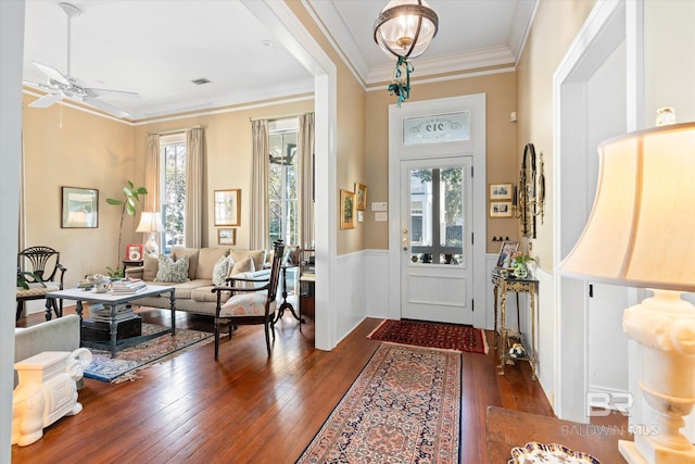 212 S Cedar St, Mobile, AL 36602 - entrance foyer with dark wood-type flooring, a ceiling fan, ornamental molding, and a wainscoted wall