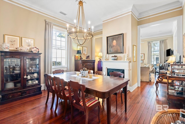 212 S Cedar St, Mobile, AL 36602 - dining space featuring a premium fireplace, wood-type flooring, a chandelier, ornamental molding, and baseboards